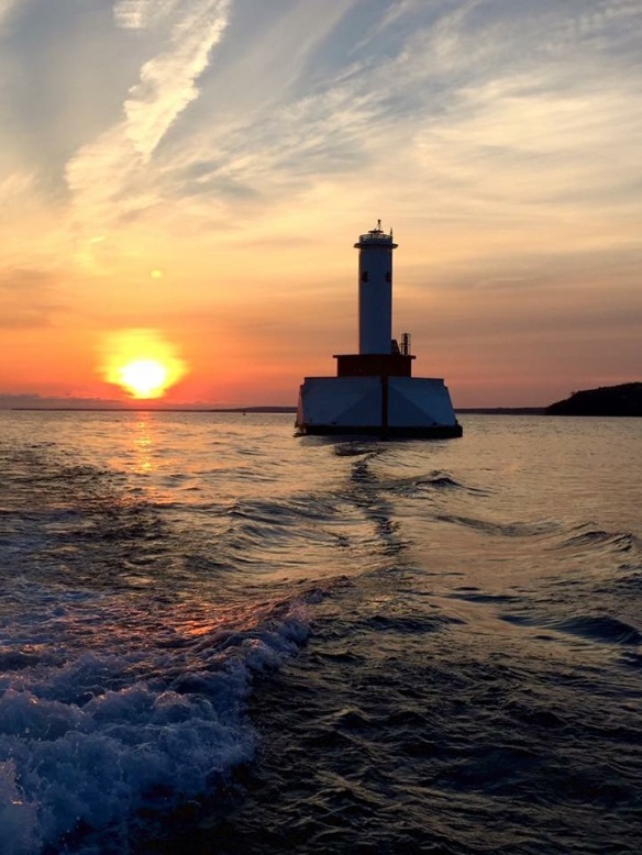 The sun and the Round Island Passage Light by Bobby Lee.